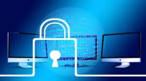 Symbolbild für IT-Sicherheit: Monitore, Schloss und digitale Datenkugel